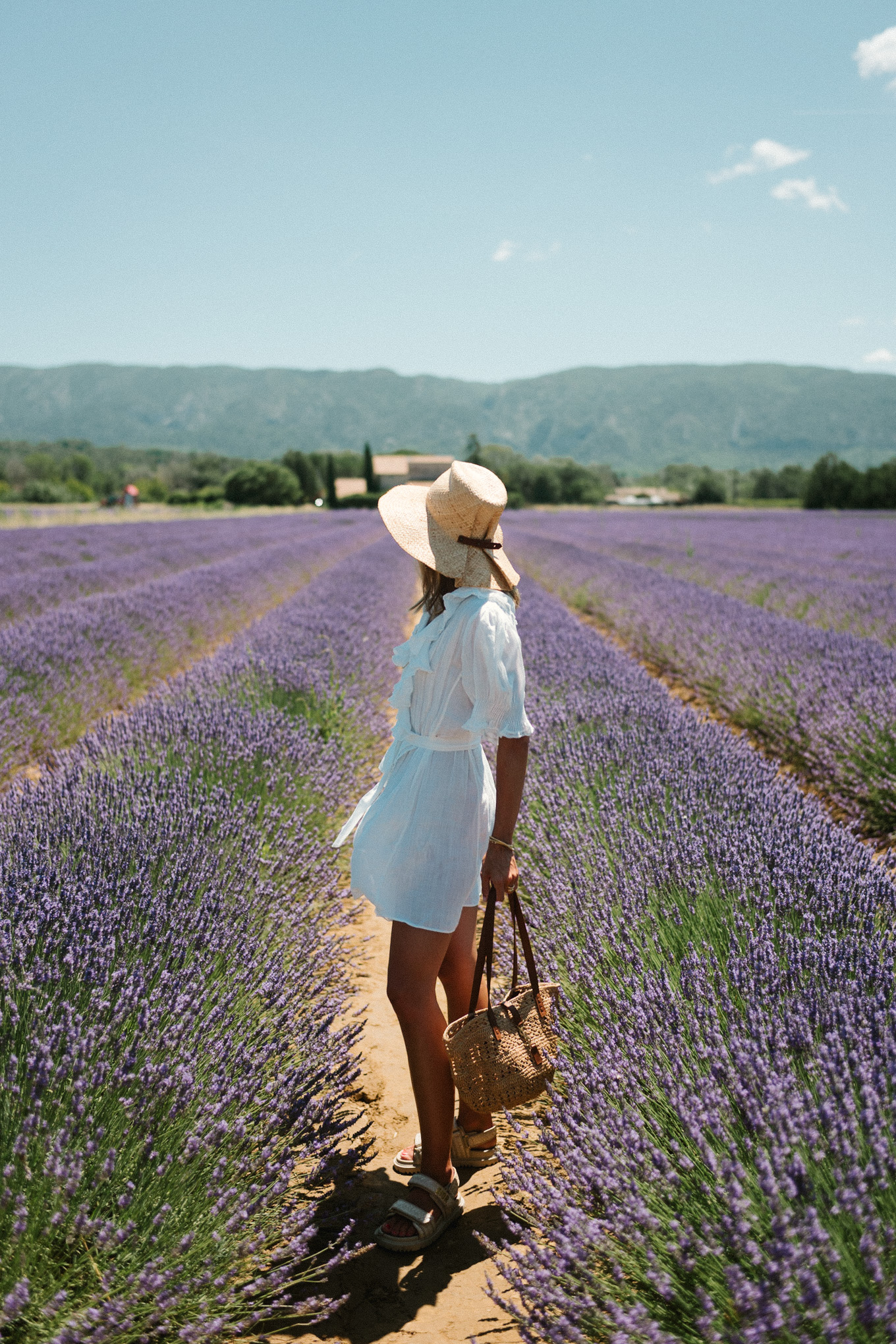 white belted ruffled minidress straw hat straw bag