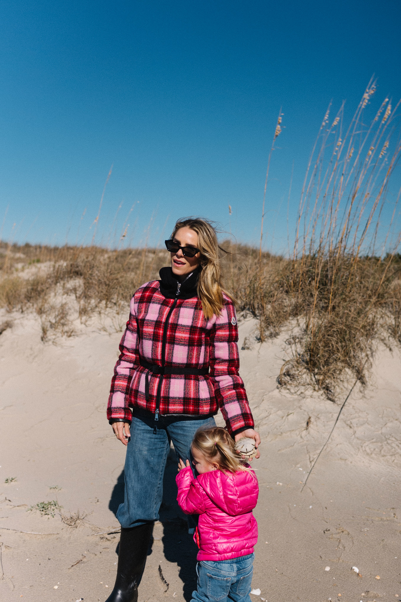 pink red plaid puffer coat blue jeans