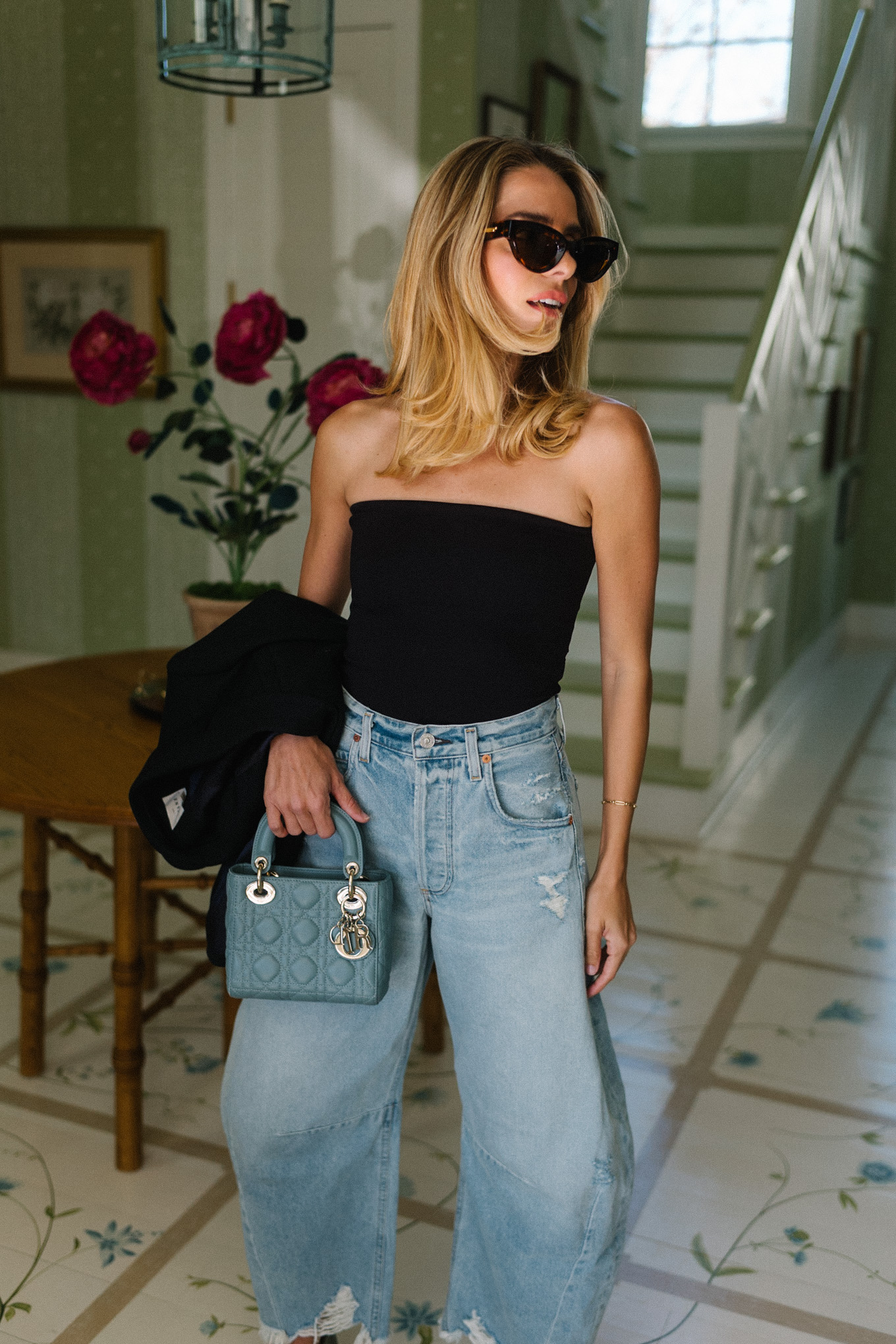 black tube top light wash horseshoe jeans