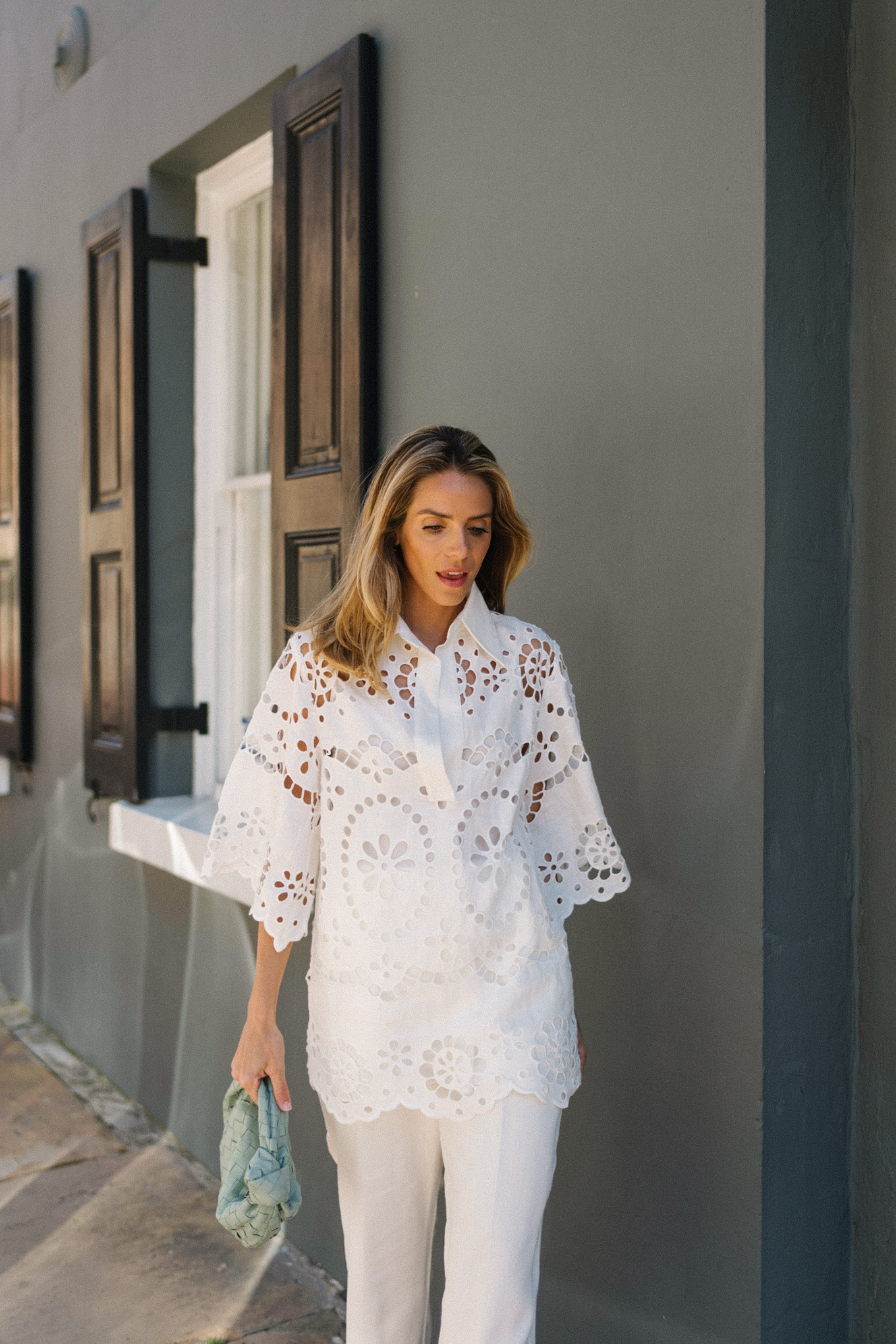 white eyelet blouse white pants seafoam green bag