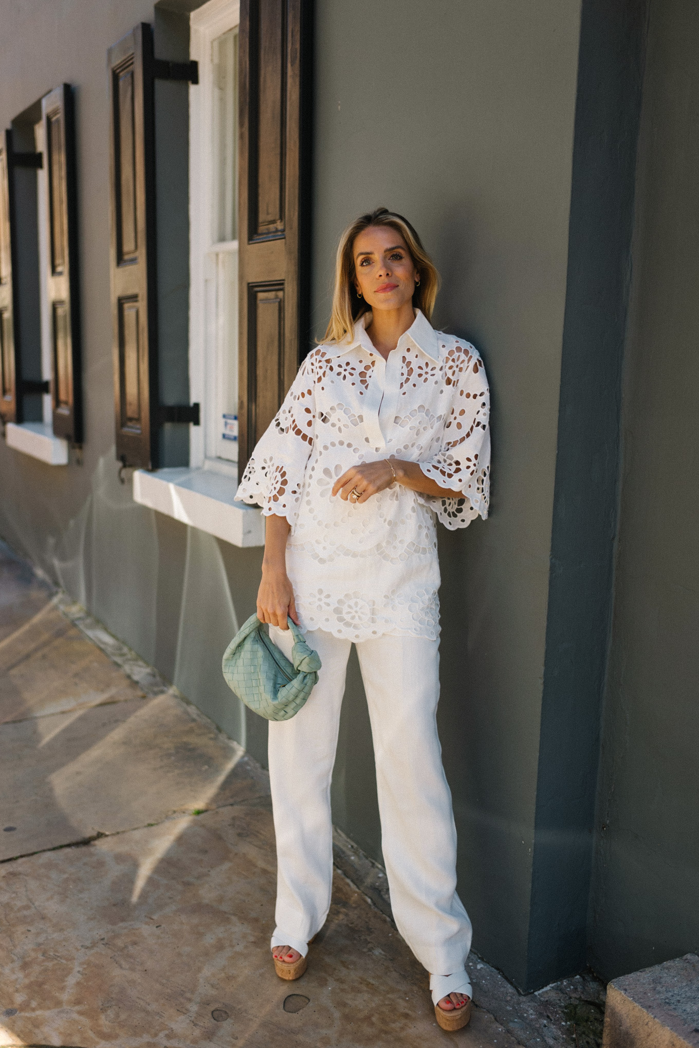 white eyelet blouse white pants seafoam green bag