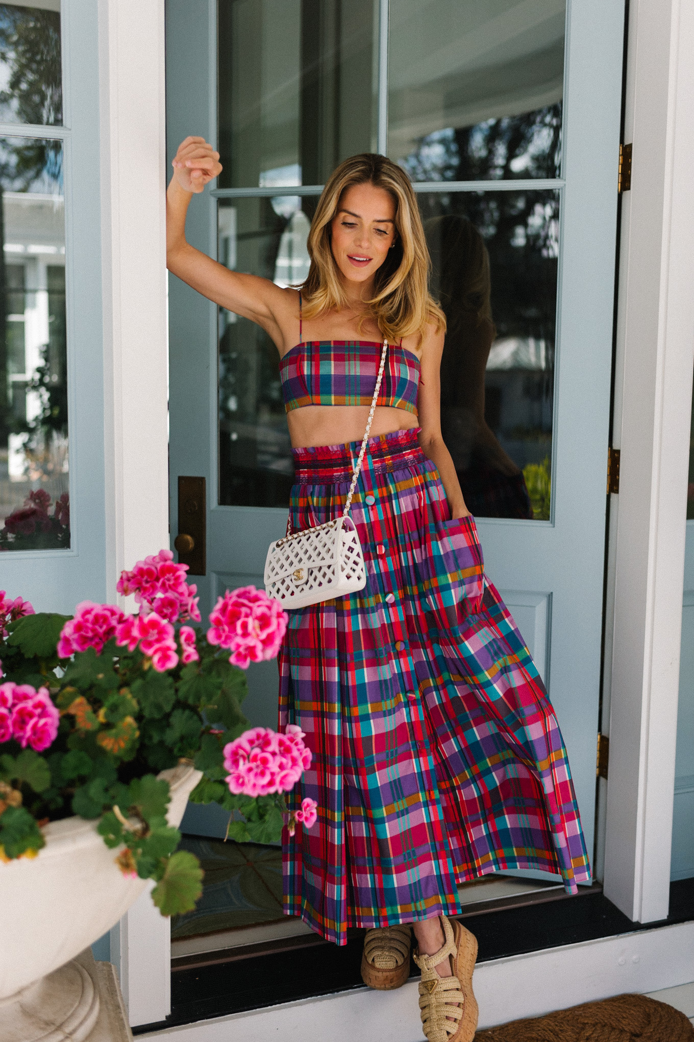 pink madras skirt and crop top set white woven bag